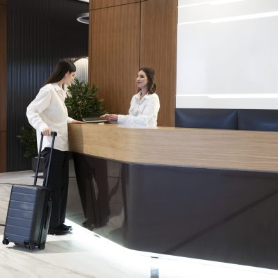 woman-talking-with-hotel-receptionist-lobby-scaled.jpg